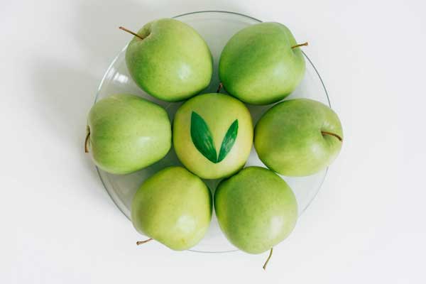 A bowl of bright and perfect fresh green apples.