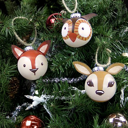 Ornaments shaped like woodland animals hang from a christmas tree