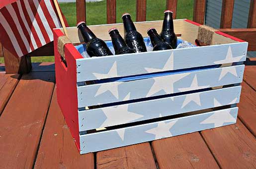 A wooden beverage cooler painted to look like the american flag