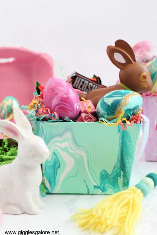 An Easter basket is decorated using acrylic paint pour for a cool look