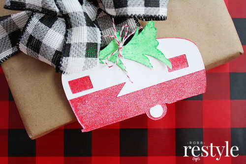 Gift tags made to look like vintage campers adorn a wrapped gift