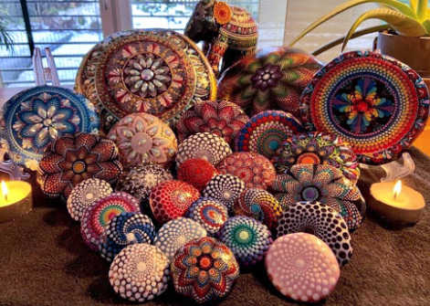 A group of stones painted with mandalas