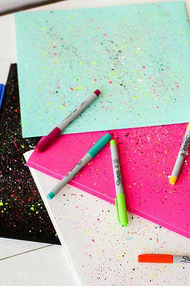 Notebooks splattered with neon paint