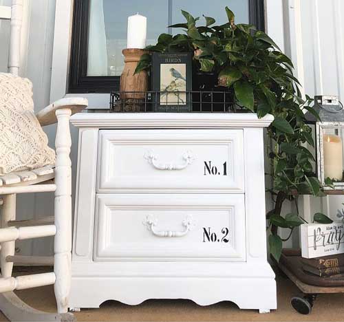 A dresser is painted and turned into a white outdoor end table
