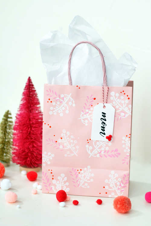 Holiday gift bags with stenciled patterns on them