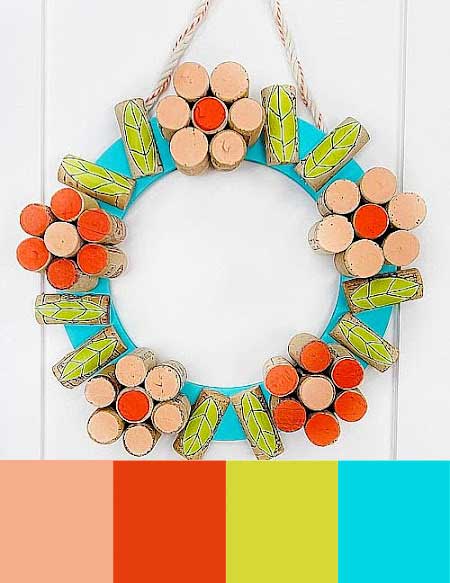 A door wreath is made of wine corks painted and arranged to look like flowers.