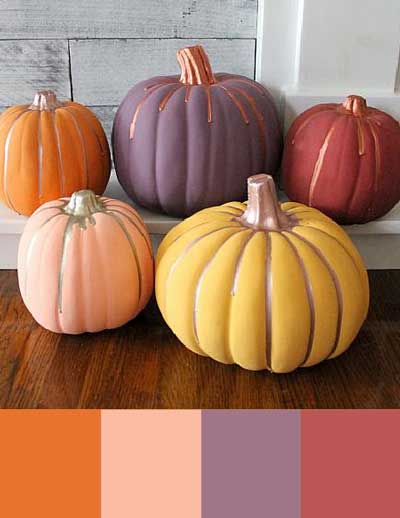 5 pumpkins are painted in warm fall colors and placed on a fireplace. Underneath is a color palette with orange, blush pink, muted plum purple, and a gray-toned raspberry.