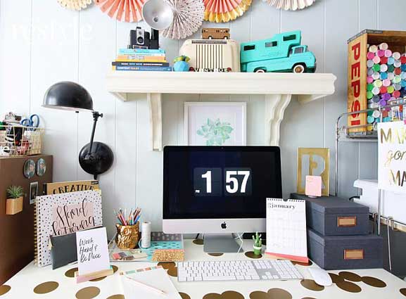 A desk in a home office decorated with colorful accessories.