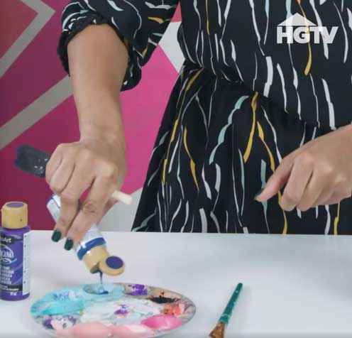 A.V. pours paint out onto a palette before she gets started on her next craft.