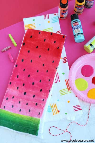 A tea towel is painted with DecoARt SoSoft fabric paint to look like a slice of watermelon