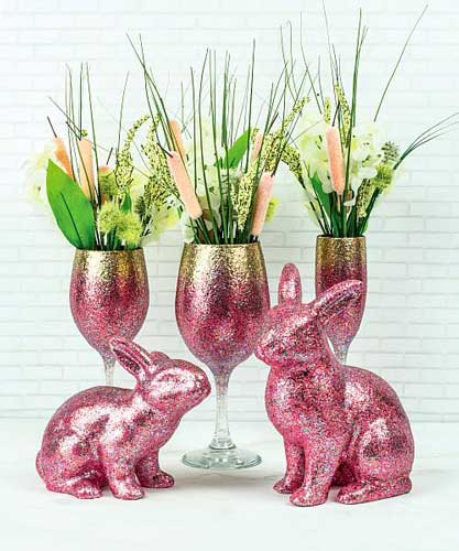 Bunny figurines are painted in pink glittery acrylic paint for a festive Easter decoration