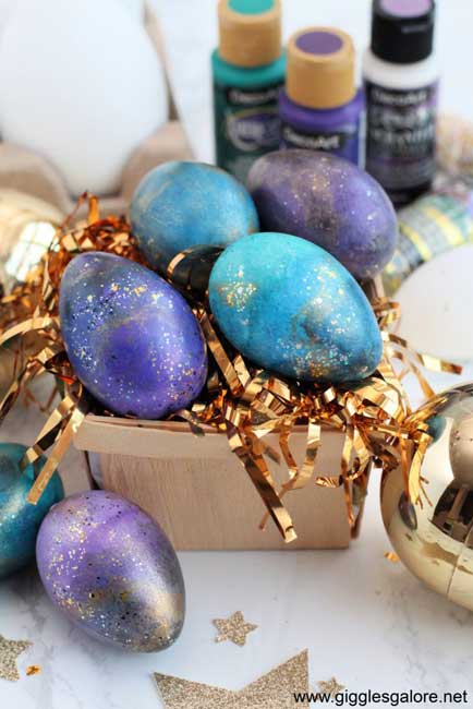 Easter eggs are given a shimmery galaxy print using acrylic paints