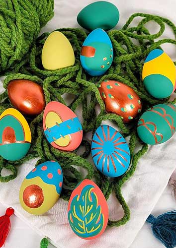Easter eggs are painted using matte and metallic acrylic paints for a modern look