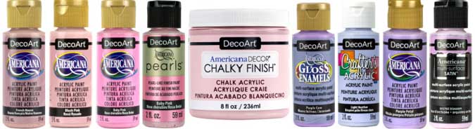 A line of different DecoArt acrylic paints in pastel pinks and purples