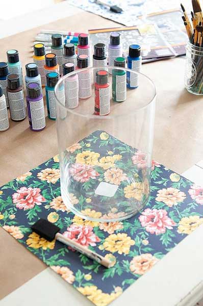 A clean glass vase is laid out prepared to be painted with acrylic paint for glass.