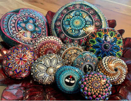 A group of stones painted with mandalas