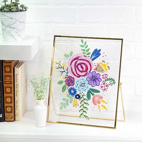 A glass frame painted with bright colorful flowers