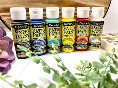 A line-up of DecoArt Patio Paint Outdoors acrylic paints.