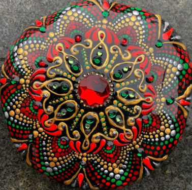 A red mandala with a gem in the middle