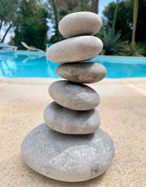 A picture of stones waiting to be painted balanced on top of one another