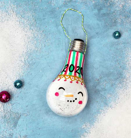 A lightbulb turned into a snowman christmas ornament
