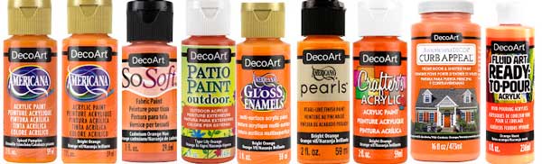 A line-up of DecoArt acrylic paint products in shades of spiced pumpkin orange.