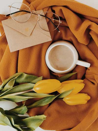 A honey brown throw blanket over a white chair