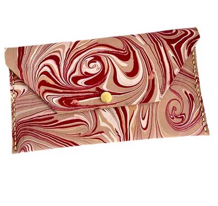 A red and white water marbled clutch